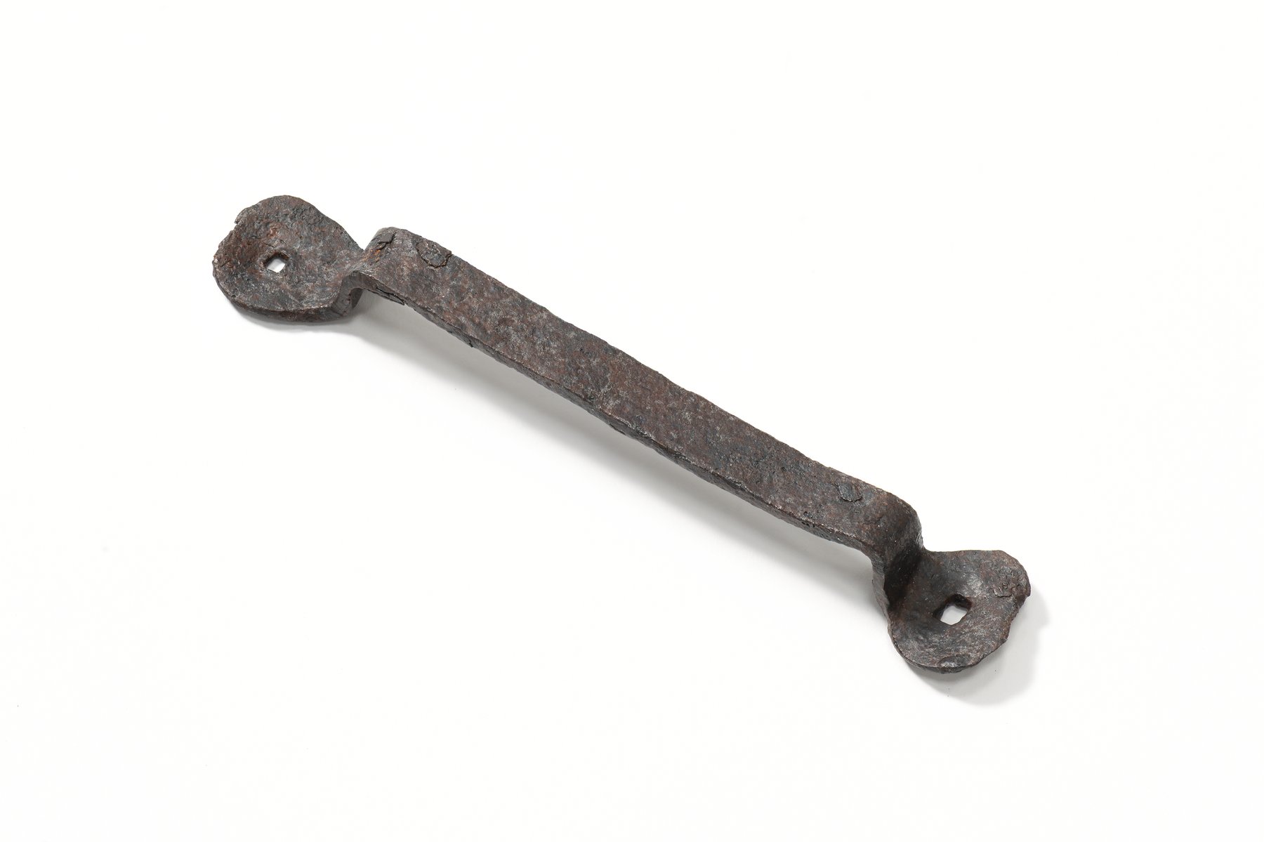 Iron handle with two preserved holes in the oval ends. 14th–15th century. 