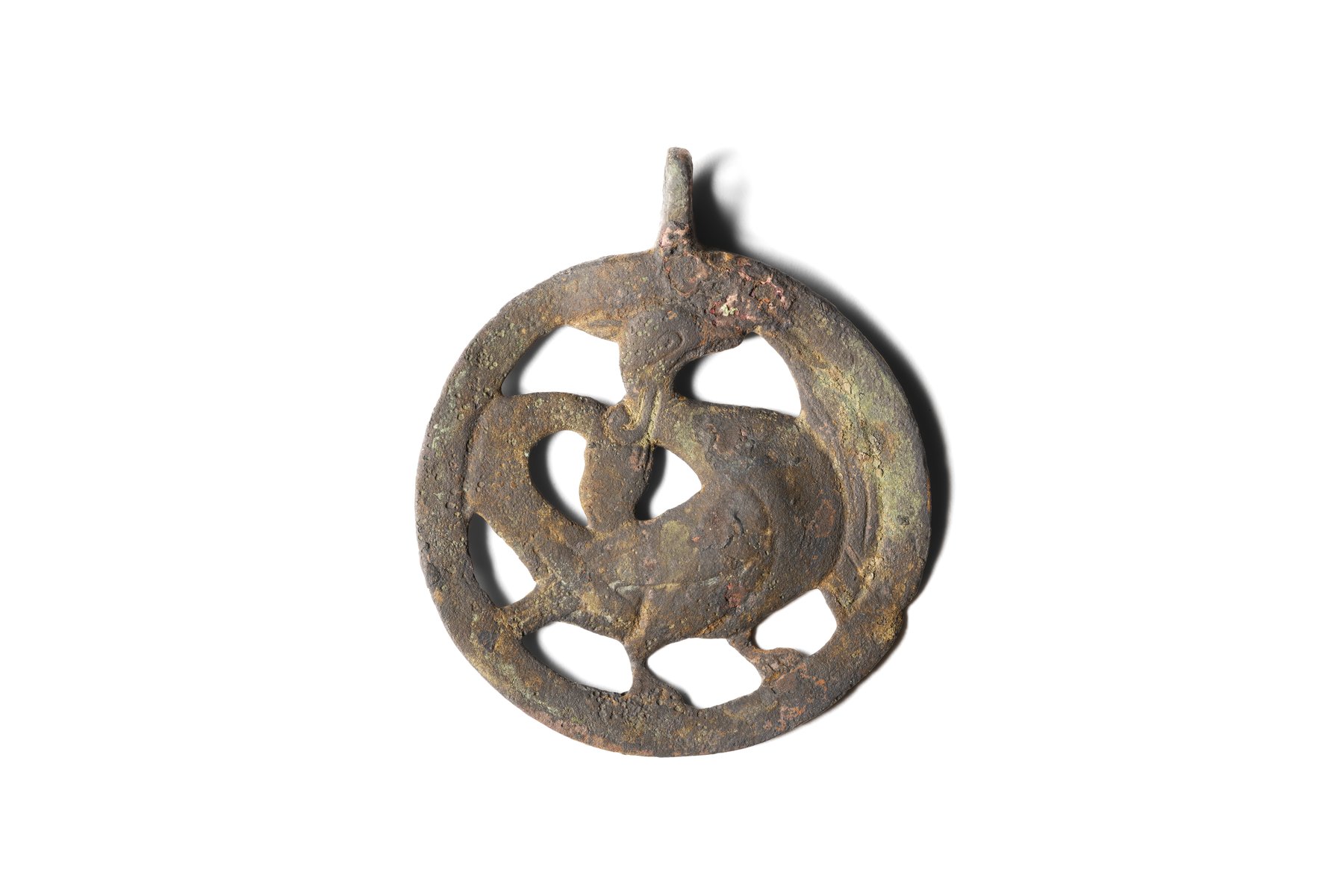 Circular copper-alloy pendant with a suspension loop, depicting a basilisk (a mythical creature with the head and body of a rooster and a serpentine tail). Second half of the 12th–13th century