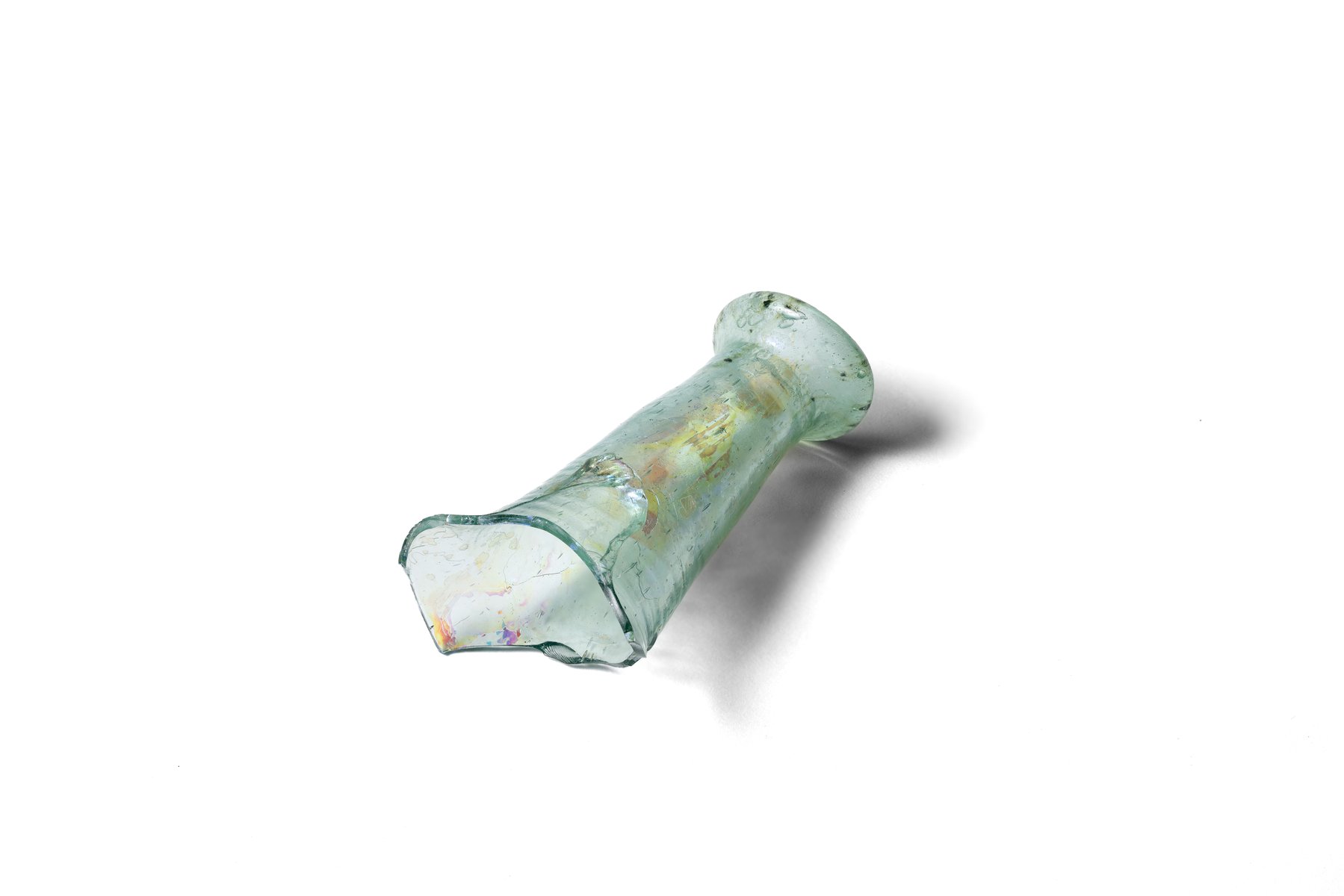 Fragment of the rim and neck of a bottle made of slightly bluish transparent glass. 14th–15th century. 
